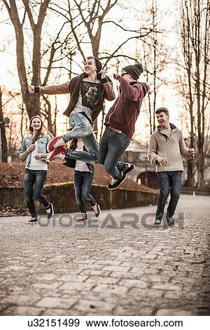 Five teenagers fooling around, jumping in park View Large Photo Image Stock Photo - Five teenagers fooling around, jumping in park. Fotosearch