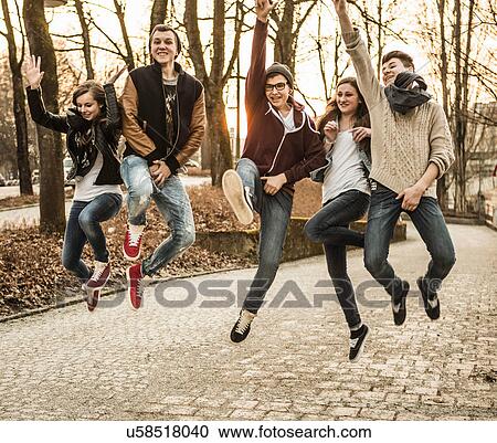 Stock Image - Five teenagers jumping. Fotosearch