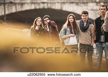Five teenagers outdoors, boy pointing at camera View Large Photo Image Stock Photography - Five teenagers outdoors, boy pointing at camera. Fotosearch