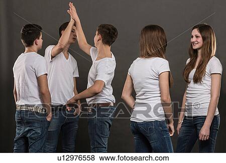Stock Photo - Five teenagers standing chatting. Fotosearch