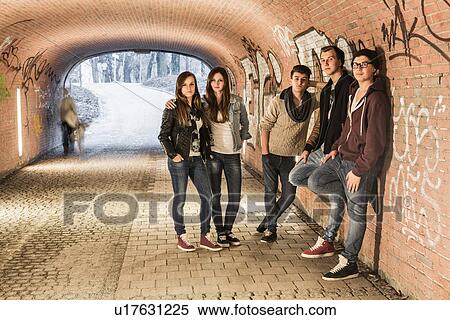Stock Photography - Five teenagers standing in underpass. Fotosearch