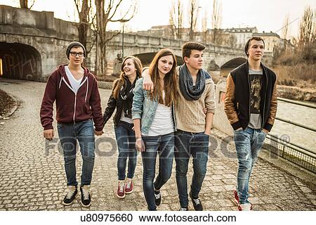 Five teenagers walking together beside river View Large Photo Image Stock Image - Five teenagers walking together beside river. Fotosearch