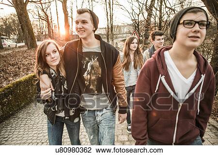 Stock Image - Five teenagers walking together. Fotosearch
