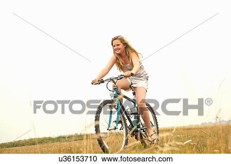 Stock Image - Girl riding bike. Fotosearch