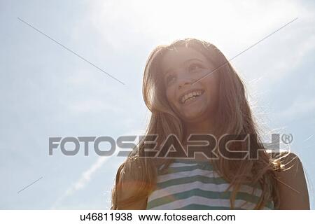 Girl smiling under hot sunny day View Large Photo Image Stock Photo - Girl smiling under hot sunny day. Fotosearch