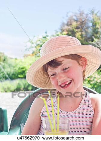 Girl wearing sunhat with soft drink View Large Photo Image Stock Image - Girl wearing sunhat with soft drink. Fotosearch