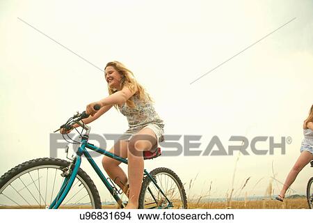 Picture - Girls riding bikes. Fotosearch