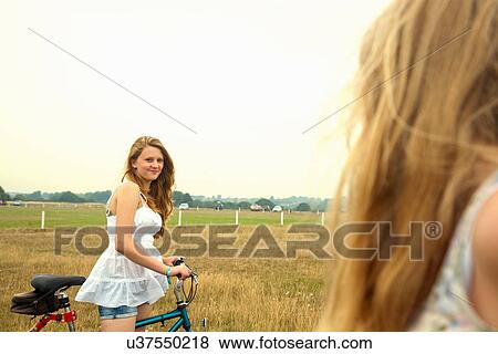 Stock Photo - Girls with bikes. Fotosearch