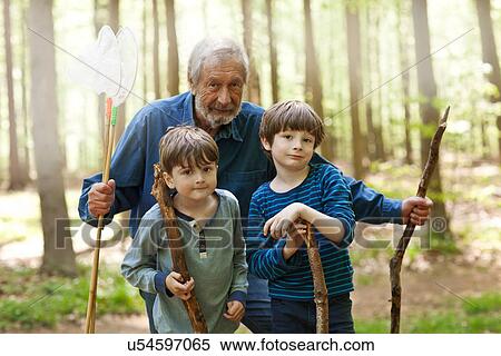 Grandfather and grandsons holding sticks in forest, portrait View Large Photo Image Stock Photography - Grandfather and grandsons holding sticks in forest, portrait. Fotosearch