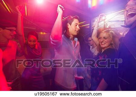Group dancing with arms raised View Large Photo Image Stock Photo - Group dancing with arms raised. Fotosearch