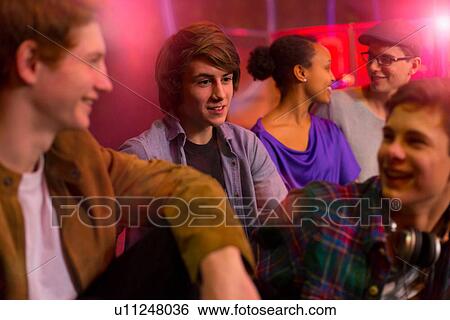 Group of friends sitting at party View Large Photo Image Stock Photograph - Group of friends sitting at party. Fotosearch