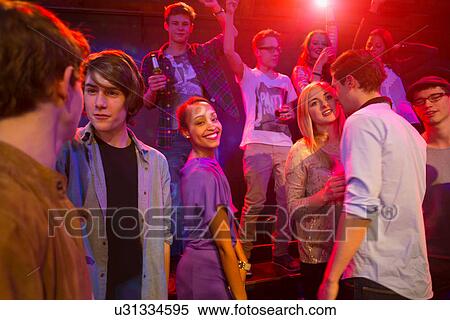 Stock Photography - Group of people at party, dancing and smiling. Fotosearch