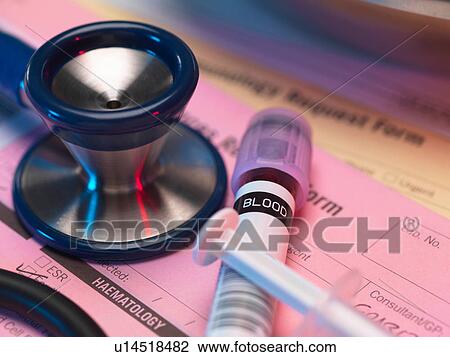 Stock Image - Haematology - Blood test with haematology request forms in clinic. Fotosearch