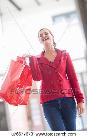 Happy young woman carrying shopping bags View Large Photo Image Stock Image - Happy young woman carrying shopping bags. Fotosearch