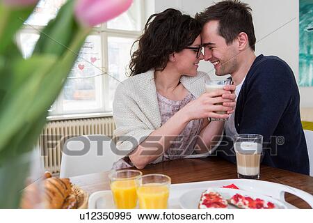 Heterosexual couple face to face at breakfast table View Large Photo Image Stock Photography - Heterosexual couple face to face at breakfast table. Fotosearch