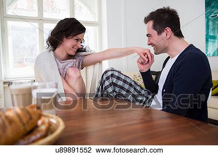 Heterosexual couple holding hands at breakfast table View Large Photo Image Stock Image - Heterosexual couple holding hands at breakfast table. Fotosearch