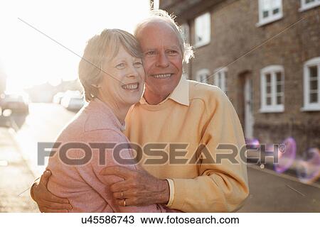 Husband and wife hugging on street View Large Photo Image Stock Image - Husband and wife hugging on street. Fotosearch