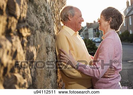 Husband and wife laughing on street View Large Photo Image Stock Image - Husband and wife laughing on street. Fotosearch