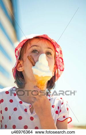 Little girl enjoying an ice cream View Large Photo Image Picture - Little girl enjoying an ice cream. Fotosearch