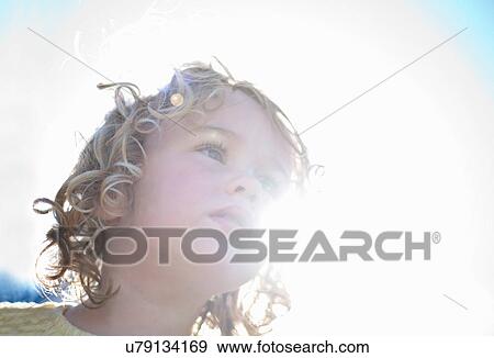 Little girl in sunlight, looking up View Large Photo Image Stock Photo - Little girl in sunlight, looking up. Fotosearch