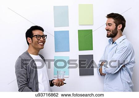 Stock Image - Male designers standing in front of color swatch. Fotosearch