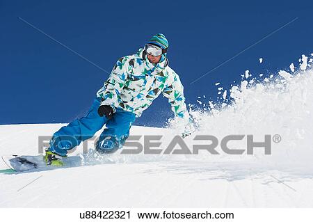 Male snowboarder in action View Large Photo Image Stock Image - Male snowboarder in action. Fotosearch