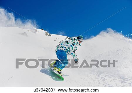Stock Photo - Male snowboarder in action. Fotosearch