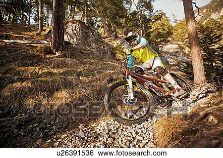 Man mountain biking on rocks View Large Photo Image Stock Photograph - Man mountain biking on rocks. Fotosearch
