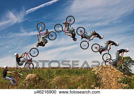 Man performing stunt on bmx bike, digital composite View Large Photo Image Stock Image - Man performing stunt on bmx bike, digital composite. Fotosearch