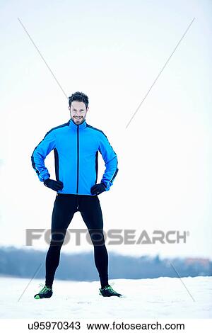 Stock Image - Man preparing for snow run. Fotosearch