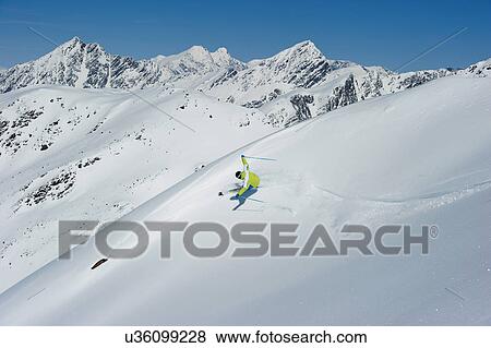 Man skiing on mountain View Large Photo Image Stock Photo - Man skiing on mountain. Fotosearch