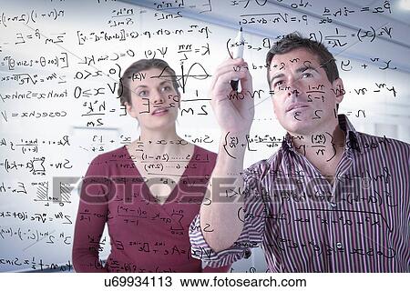 Stock Image - Mathematicians writing complex scientific equations on screen. Fotosearch