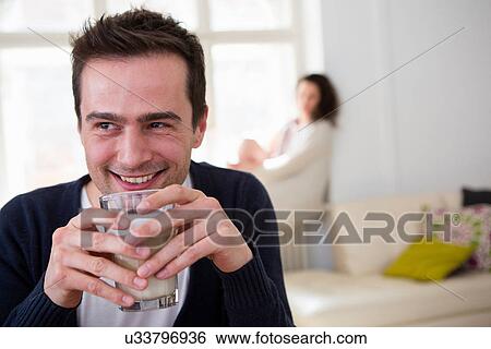 Stock Photograph - Mature man drinking a smoothie. Fotosearch