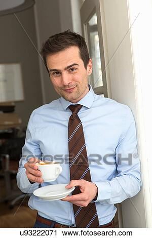 Mature man wearing shirt and tie holding cup of coffee View Large Photo Image Stock Image - Mature man wearing shirt and tie holding cup of coffee. Fotosearch