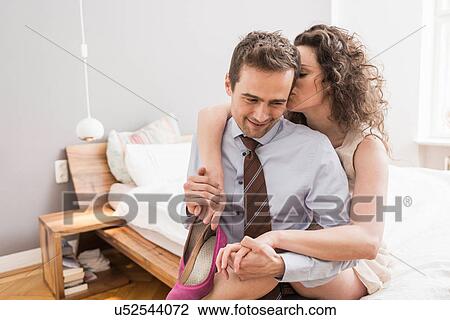Mid adult couple face to face with arm around, smiling and holding shoe View Large Photo Image Stock Image - Mid adult couple face to face with arm around, smiling and holding shoe. Fotosearch