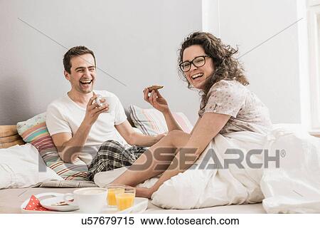 Mid adult couple having breakfast in bed View Large Photo Image Stock Photography - Mid adult couple having breakfast in bed. Fotosearch
