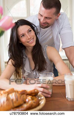 Picture - Mid adult couple having breakfast. Fotosearch