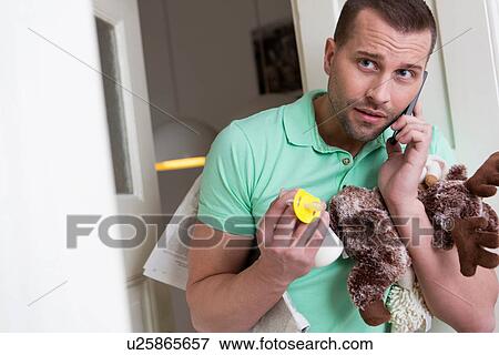 Mid adult man holding cuddly toy and baby's pacifier View Large Photo Image Stock Photo - Mid adult man holding cuddly toy and baby's pacifier. Fotosearch