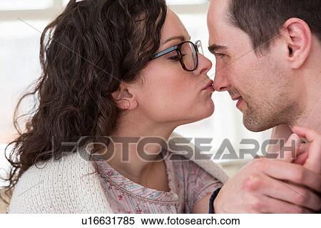 Mid adult woman giving man a kiss on the nose View Large Photo Image Stock Photography - Mid adult woman giving man a kiss on the nose. Fotosearch