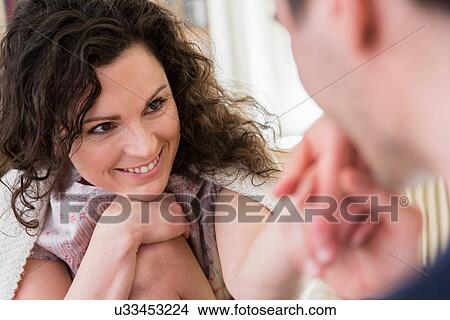 Mid adult woman smiling at partner View Large Photo Image Picture - Mid adult woman smiling at partner. Fotosearch