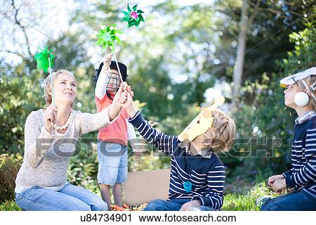 Mother and boys playing outdoors View Large Photo Image Stock Image - Mother and boys playing outdoors. Fotosearch
