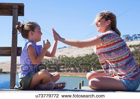 Mother and daughter playing pat a cake View Large Photo Image Stock Image - Mother and daughter playing pat a cake. Fotosearch