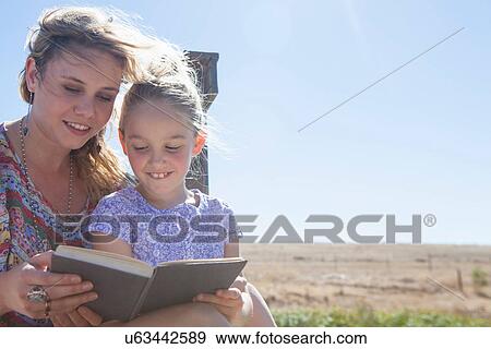 Mother and daughter reading book View Large Photo Image Stock Photo - Mother and daughter reading book. Fotosearch