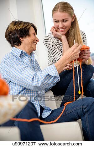Stock Photo - Mother teaching daughter kitting. Fotosearch