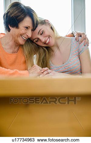 Mother with arm around daughter View Large Photo Image Stock Image - Mother with arm around daughter. Fotosearch