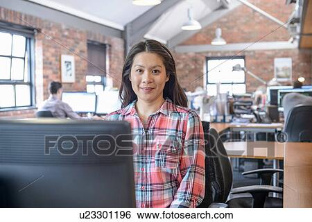 Office worker at desk, portrait View Large Photo Image Stock Photograph - Office worker at desk, portrait. Fotosearch