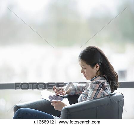 Office worker using digital tablet by window of office View Large Photo Image Stock Image - Office worker using digital tablet by window of office. Fotosearch