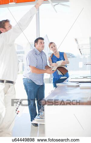 Stock Photo - People looking in kitchen showroom. Fotosearch