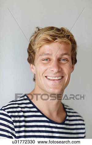 Portrait of a young man in striped tshirt View Large Photo Image Stock Image - Portrait of a young man in striped tshirt. Fotosearch