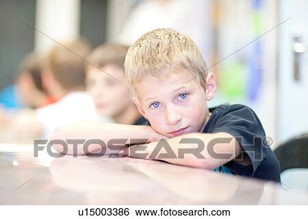Portrait of boy leaning on elbows View Large Photo Image Stock Photograph - Portrait of boy leaning on elbows. Fotosearch